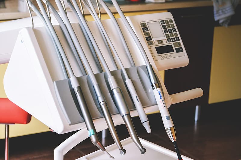 Electric dental tools, including a drill in a dentist's office